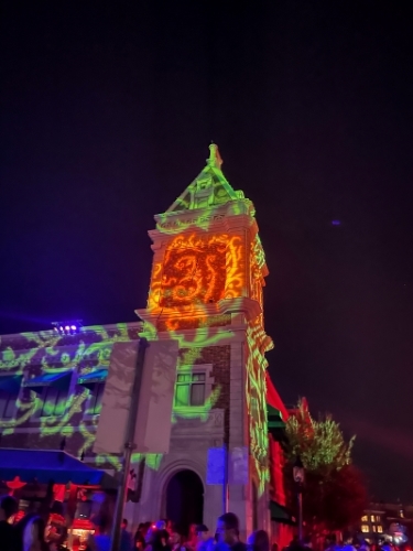 A tower lit in orange, green, and purple at Halloween Horror Nights at Universal Orlando.