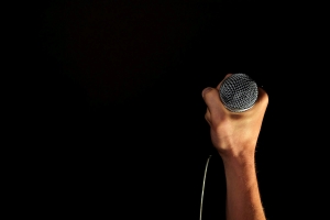 Hand and microphone stock image for Orlando Kia Center Events.