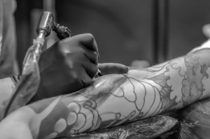 Black and white image of an arm getting tattooed, fitting for the tattoo festival at the Orange County Convention Center.